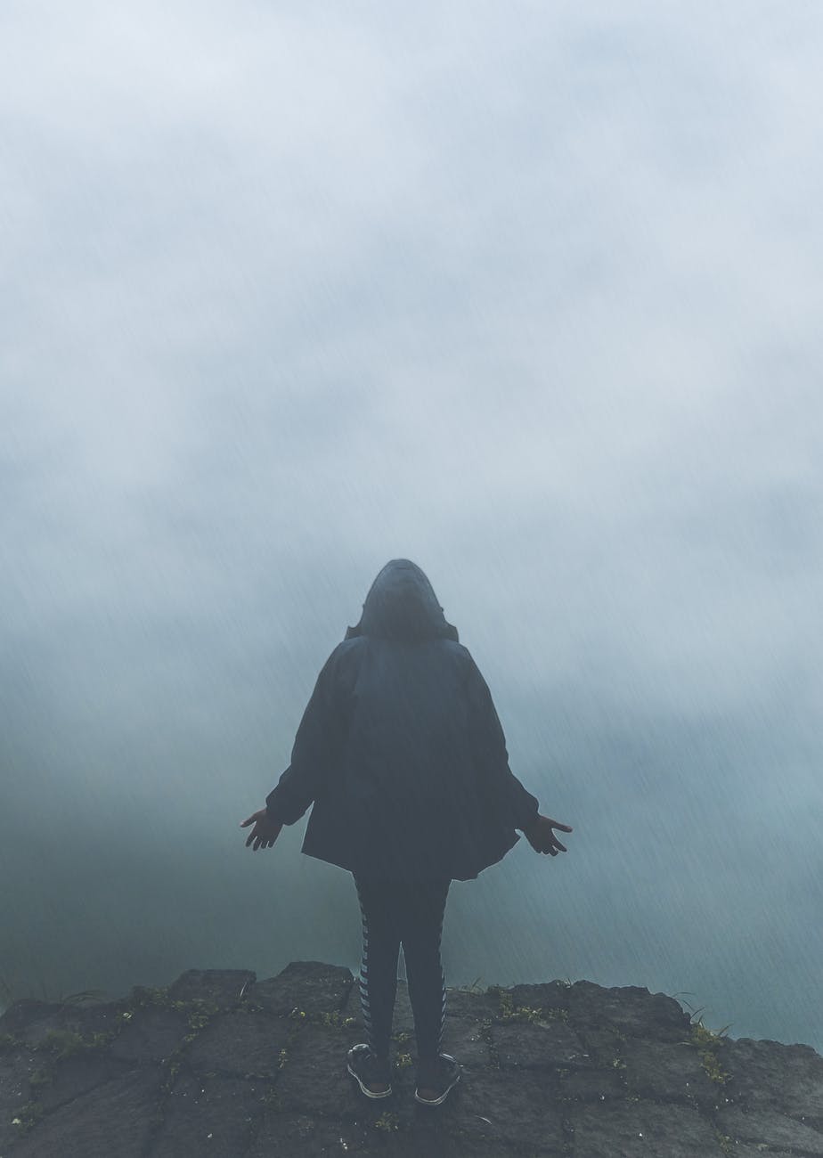 back view of person standing in fog