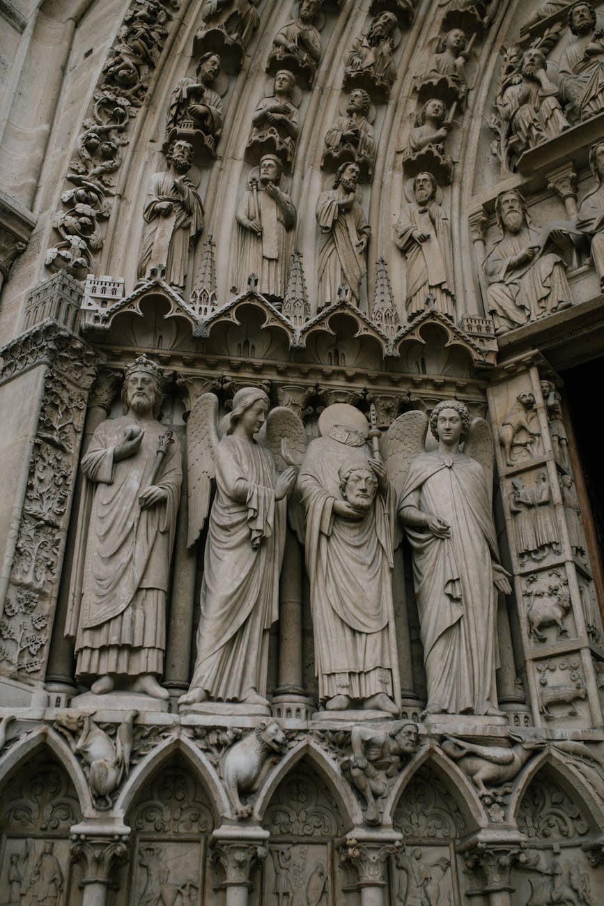 medieval statues of saints on stone entrance of church