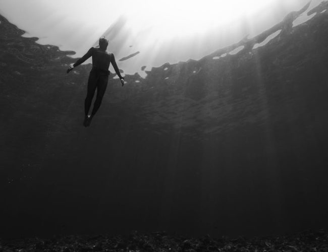 unrecognizable diver swimming underwater